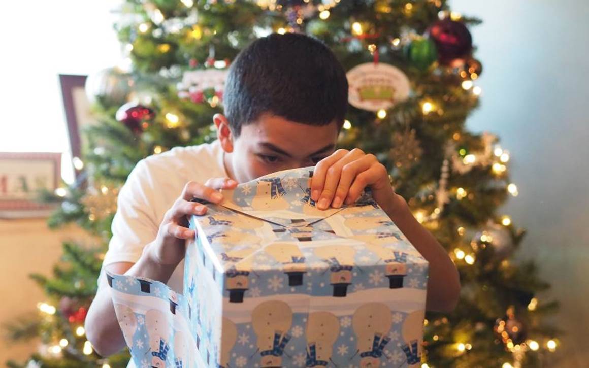 Teen boy opening presents